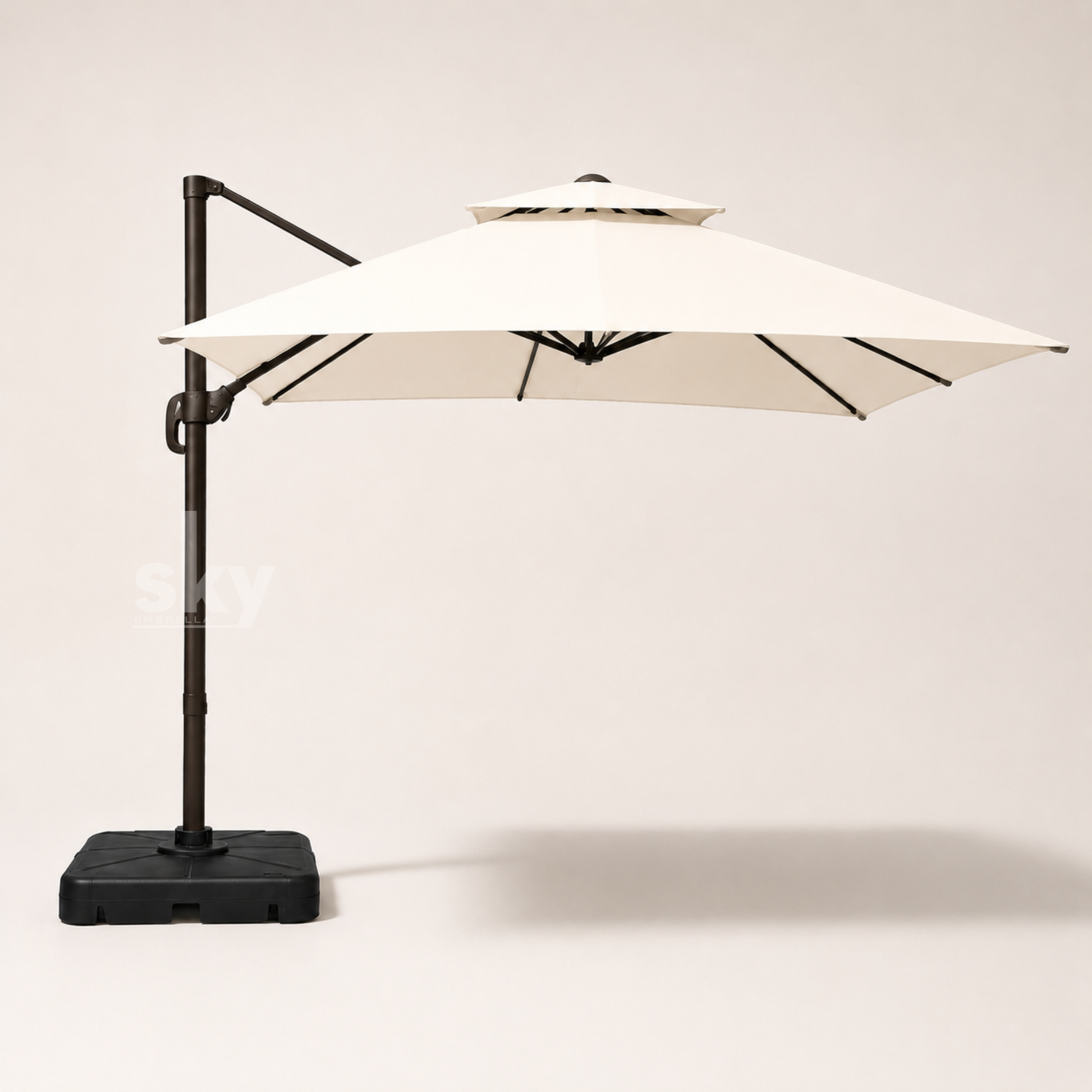 A double top deluxe square patio umbrella with an off white canopy and a black metal frame and base, shown against a neutral light beige background.