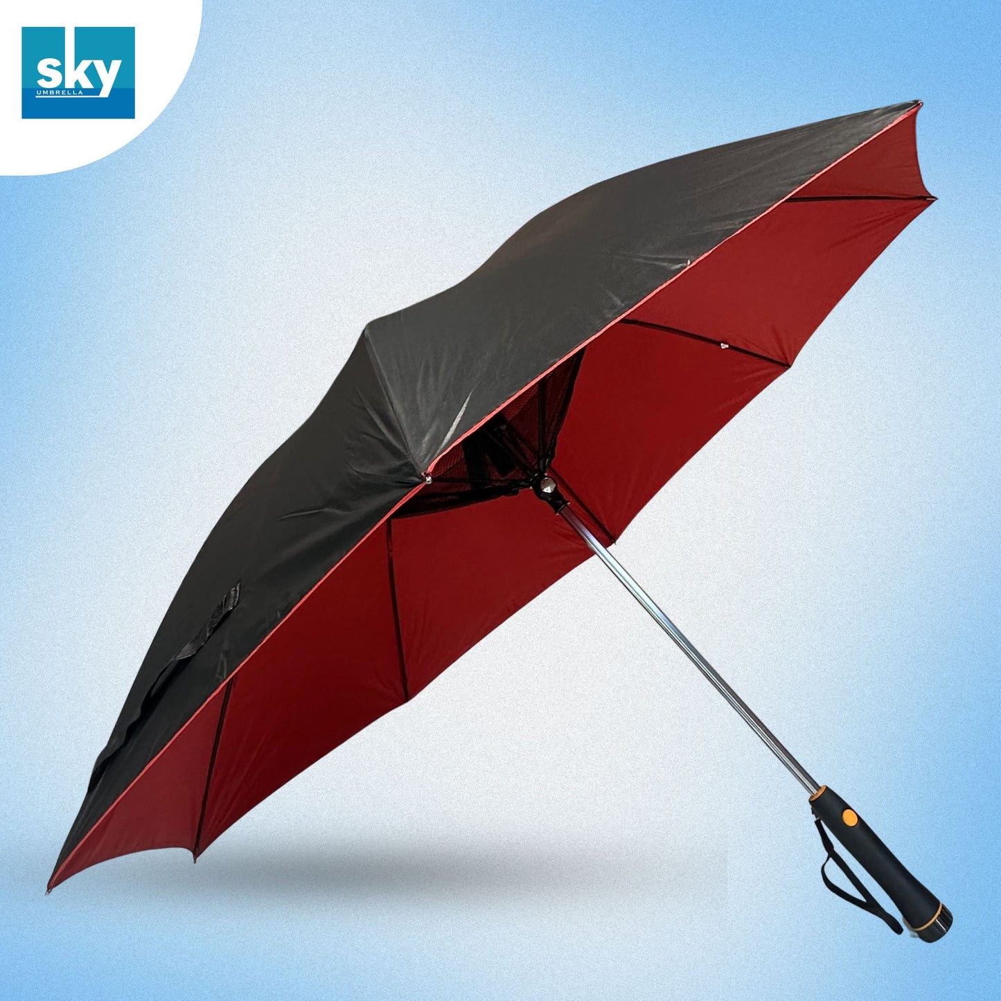 Fan umbrella shown open at an angle, featuring a black outer canopy and a red inner canopy, with a silver metal shaft and a black handle. 