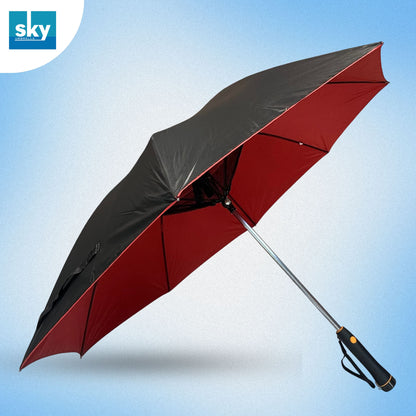 Fan umbrella shown open at an angle, featuring a black outer canopy and a red inner canopy, with a silver metal shaft and a black handle. 