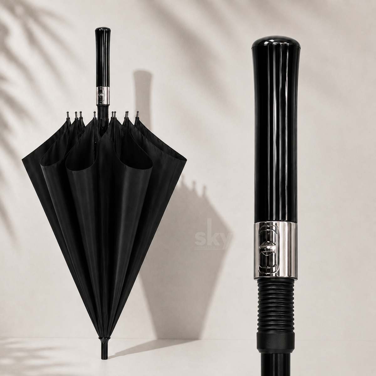 A black umbrella shown open on the left and a close-up of its glossy black handle on the right, set against a light beige wall with soft leaf shadows.