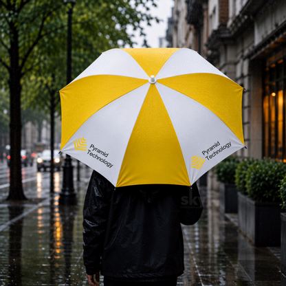 A person in a black raincoat holding a large yellow and white umbrella on a wet city street in the rain. The umbrella has the 'Pyramid Technology' logo printed on the white panels.