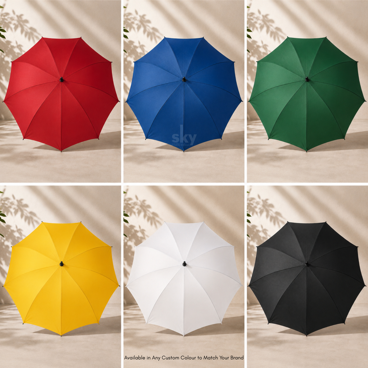 Six open umbrella color options arranged in a 2x3 grid: red, blue, green, yellow, white, and black. Each umbrella is shown against a warm beige background with soft leaf shadows. Also available in any custom colour to match your brand.