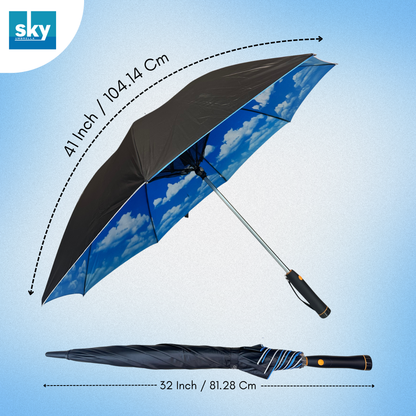 A promotional product image showing a blue sky cloud-print umbrella open and closed on a light blue gradient background. The open umbrella has a black canopy top and a blue sky pattern on the underside, with dimension indicating 46 inches/ 104.14 Cm. And the closed dimensions are 32 Inch / 81.28Cm