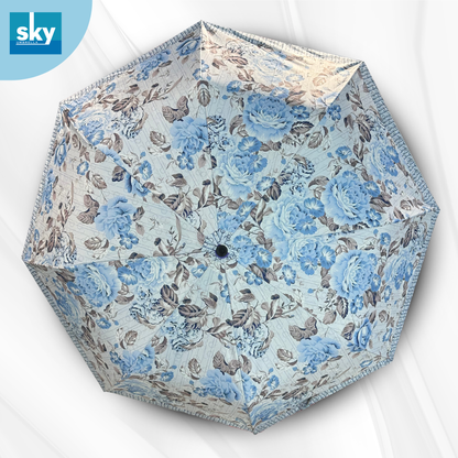 An open umbrella viewed from above, featuring a light blue and grey floral print. 