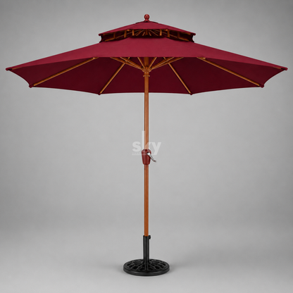 A double-tiered patio umbrella with a maroon canopy, brown wooden pole finish, and black metal base on a neutral gray background.