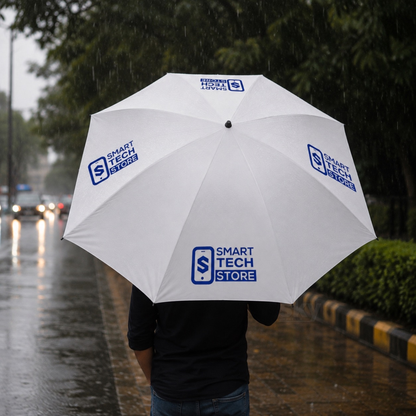 A person holding a large white umbrella branded with 'SMART TECH STORE' logos, standing on a wet city street in the rain.